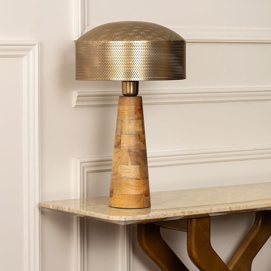 Gold metal table lamp with textured shade and handcrafted wooden base for elegant bedside and console table styling.