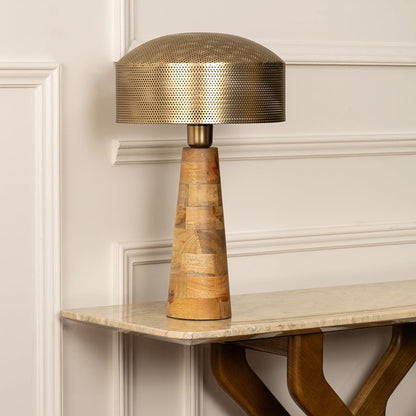 Gold metal table lamp with textured shade and handcrafted wooden base for elegant bedside and console table styling.