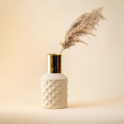 Textured white vase with gold neck and pampas grass for sophisticated home decor and interior styling.