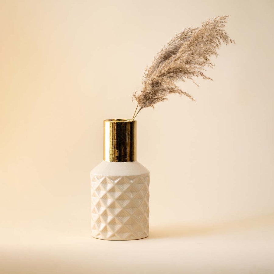 Textured white vase with gold neck and pampas grass for sophisticated home decor and interior styling.