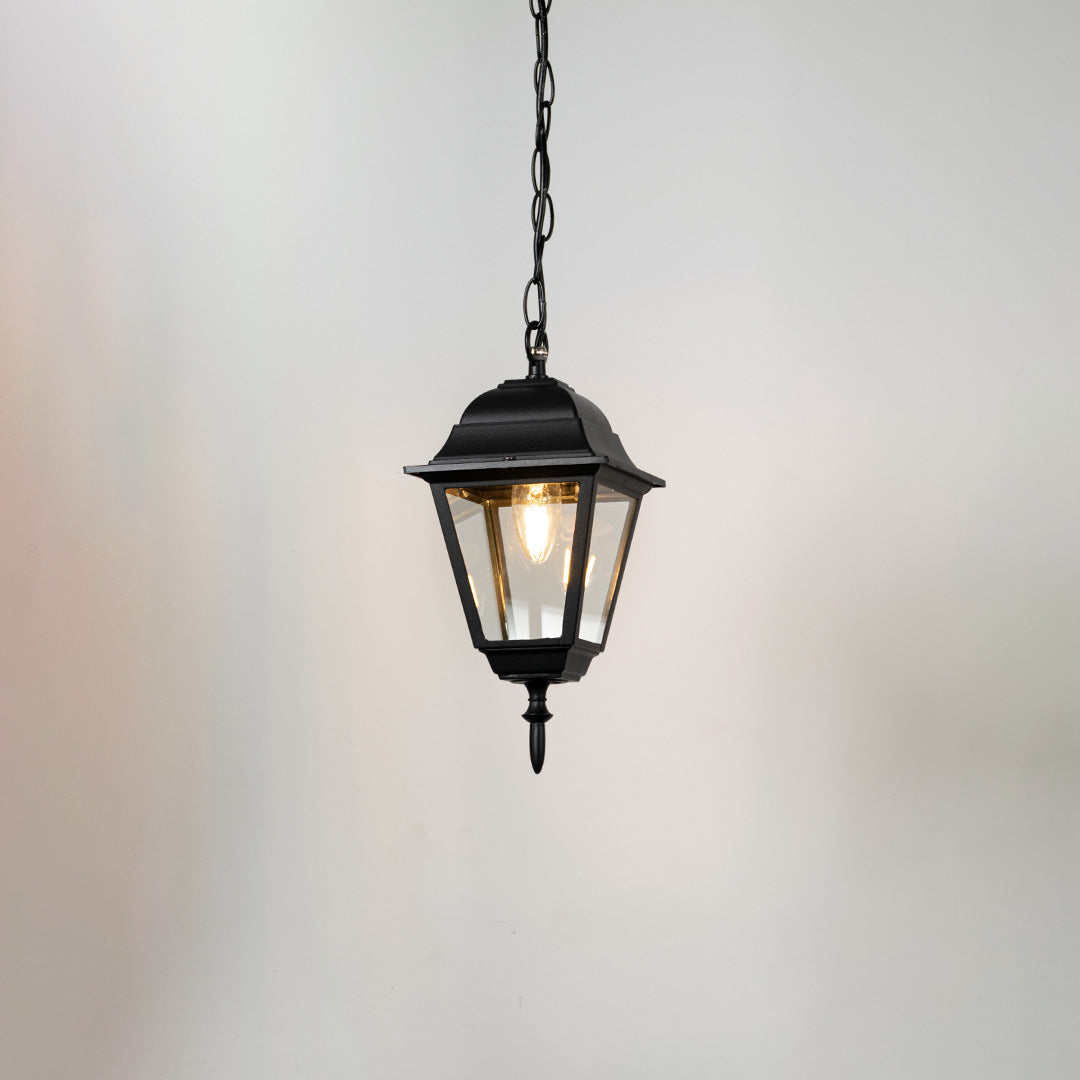 Contemporary black metal hanging lantern light with clear glass shade for balcony and patio lighting.