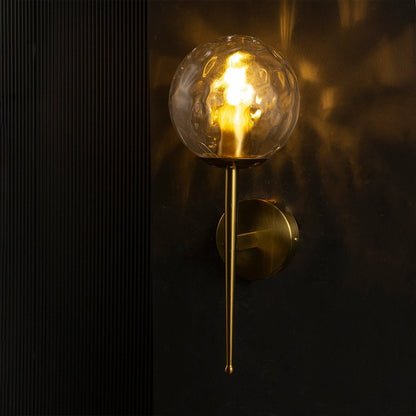 Mid Century Style Round Clear Glass Golden Wall Lamp On Black Background