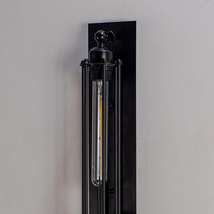 Close up wall light with black metal finish and tubular bulb on dark background modern industrial lighting for home decor.