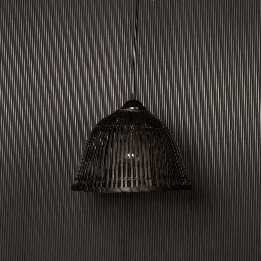 Elegant black rattan pendant lamp highlighted on dark background ideal for modern rustic interior styling.