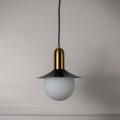 White glass pendant light with black metal shade and brass accents crafted for modern interiors.