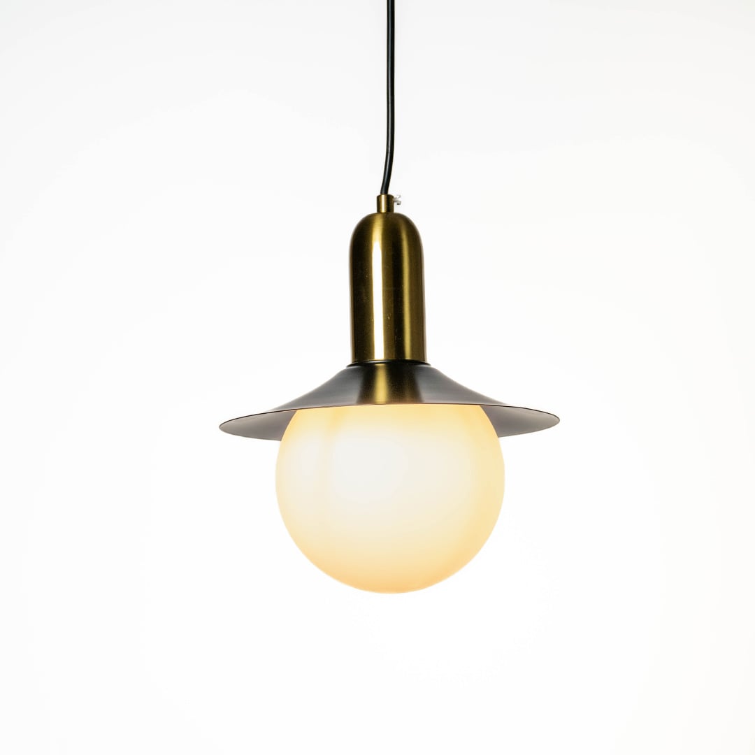 White glass pendant light with black metal shade and brass accents crafted for modern interiors.