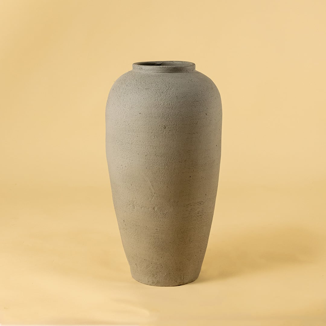 Grey textured ceramic vase on white background highlighting its tall minimal shape ideal for living room console and hallway decor.