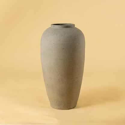 Grey textured ceramic vase on white background highlighting its tall minimal shape ideal for living room console and hallway decor.