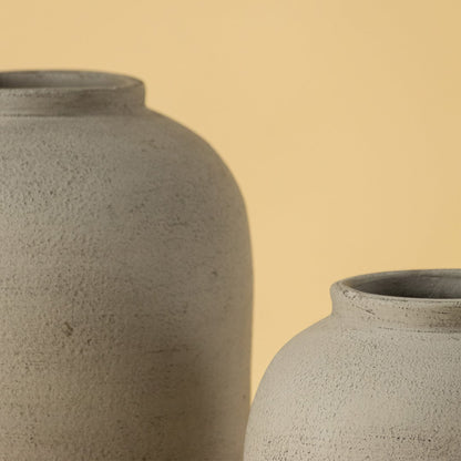 Detailed closeup of grey ceramic vase showing fine textured surface and smooth curved shape perfect for modern interior styling.