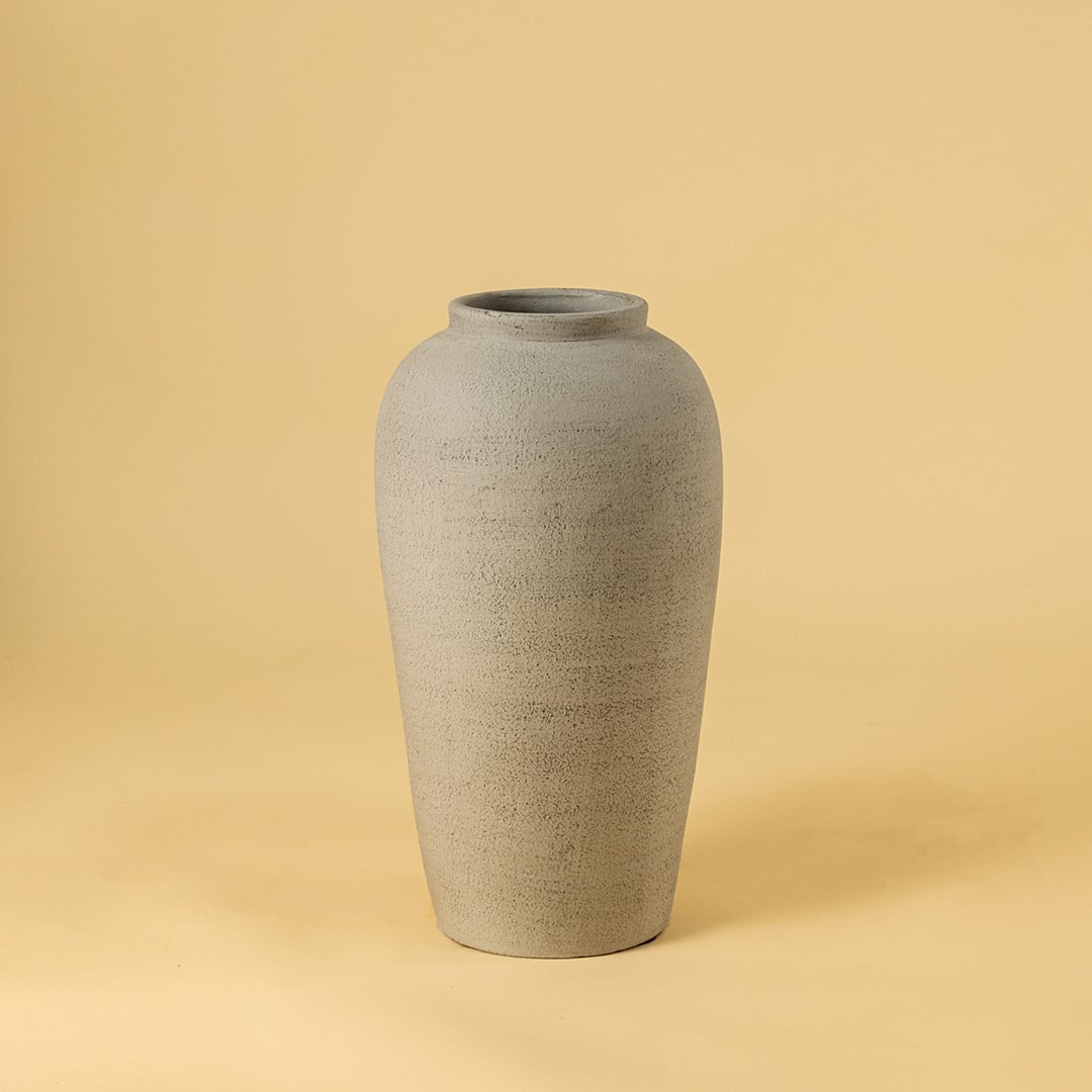 Grey textured ceramic vase on white background highlighting its tall minimal design ideal for modern living room and hallway decor.\