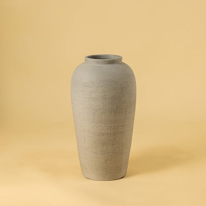 Grey textured ceramic vase on white background highlighting its tall minimal design ideal for modern living room and hallway decor.\