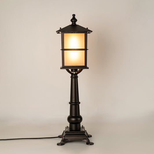 Vintage black outdoor garden light with warm glowing panels for luxury exterior decor styling use.