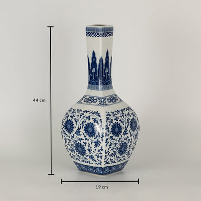 Blue and white ceramic jar with tall narrow neck and floral artwork displayed with dimensions of 44 cm height and 19 cm width creating an elegant artistic presence.