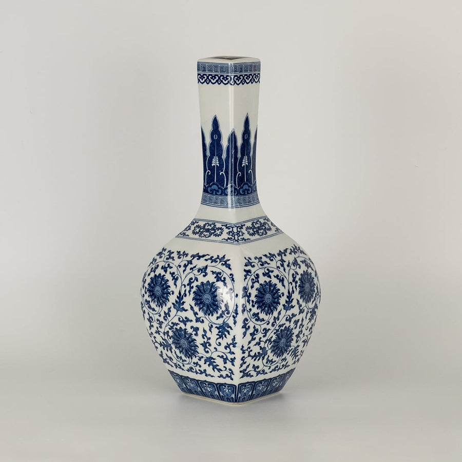Blue and white ceramic jar with a tall narrow neck covered in intricate floral patterns presented in a studio setting creating a classic artistic presence suited for elegant decor.
