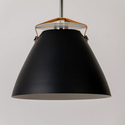 Closeup of black pendant light showing premium matte finish and tan leather strap connecting the metal frame.