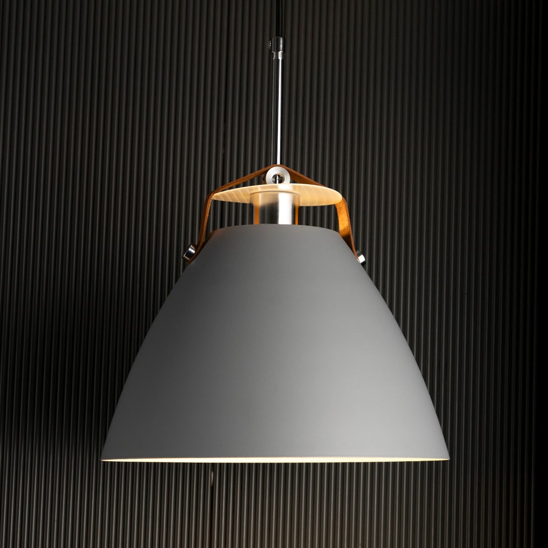 Grey pendant light illuminated softly highlighting its smooth contours and subtle reflective metallic details.