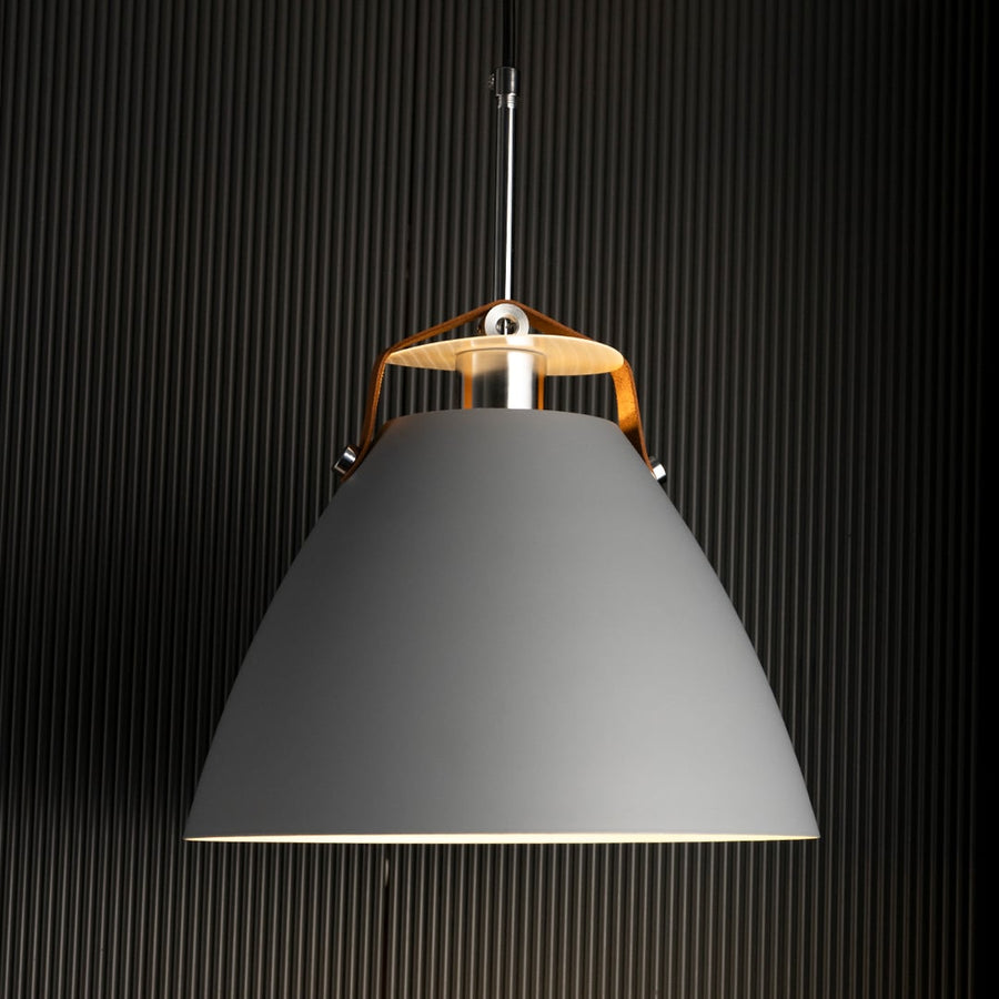 Grey pendant light illuminated softly highlighting its smooth contours and subtle reflective metallic details.