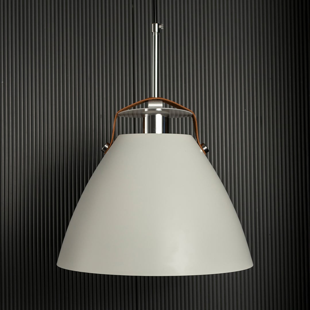 White pendant light softly light off on dark background showcasing its smooth elegant shape and detailing.