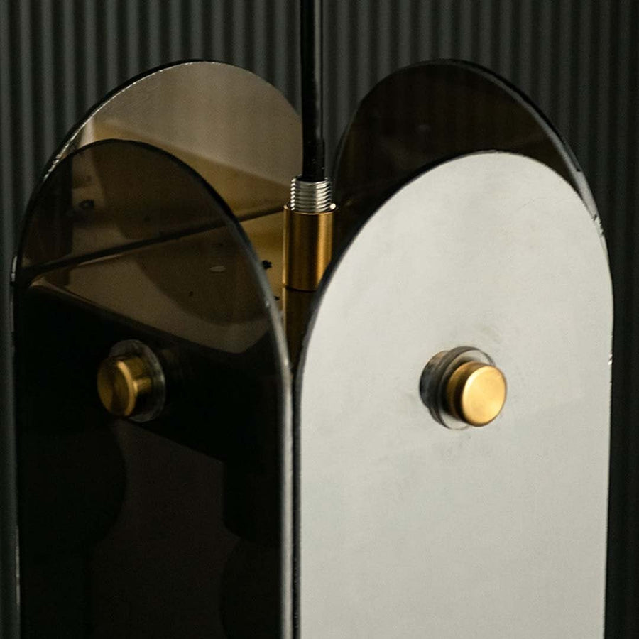 Closeup view capturing smoked glass panels and gold frame details highlighting premium finish smooth curves and high quality craftsmanship.