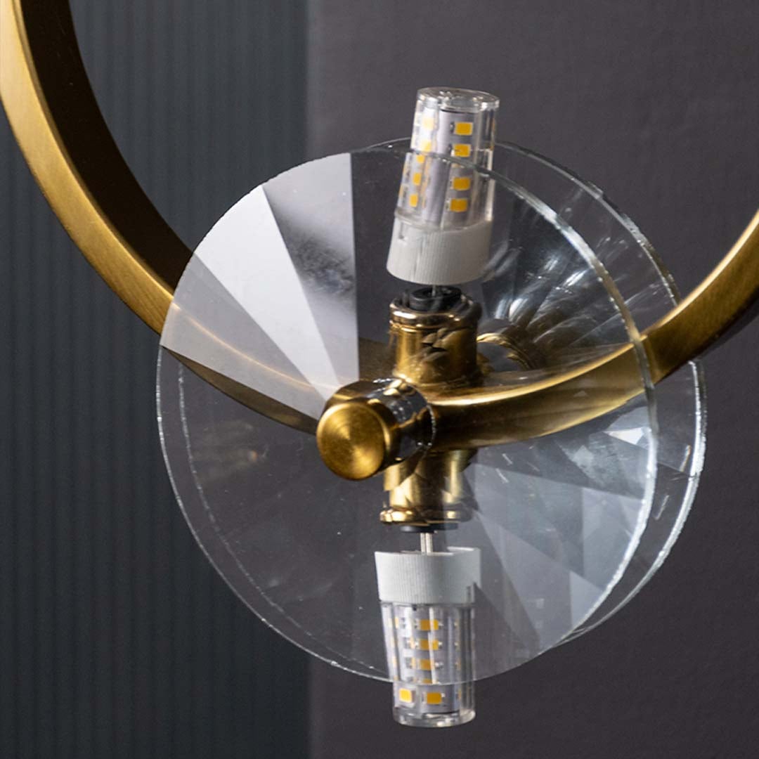 Macro style closeup of gold metal ring wall light showcasing its warm glow and crystal clear detailing for modern decorative home lighting.