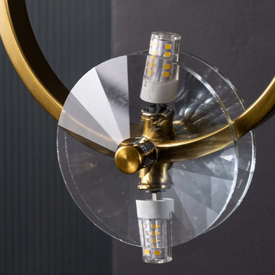 Macro style closeup of gold metal ring wall light showcasing its warm glow and crystal clear detailing for modern decorative home lighting.