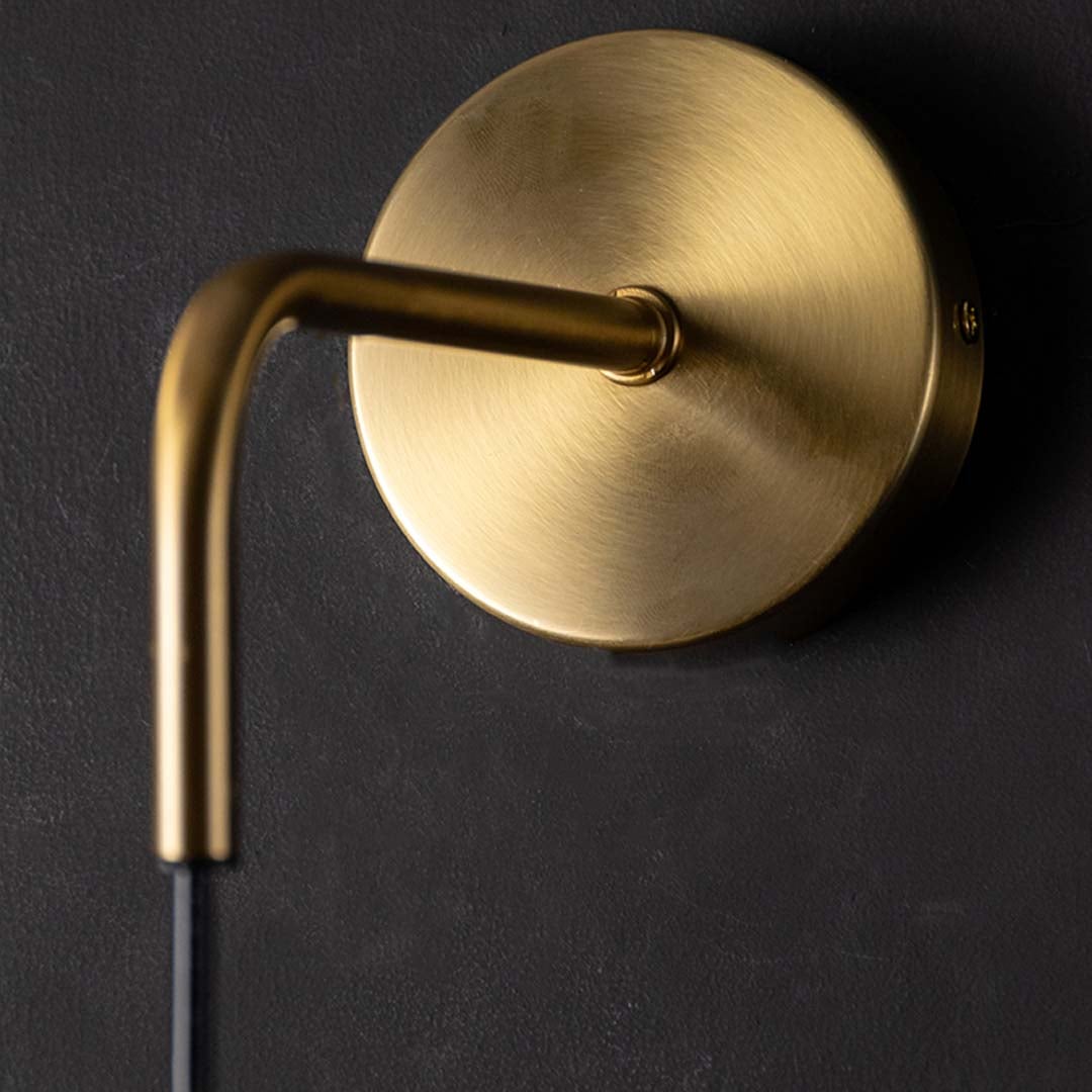 Closeup view of the gold ring wall light showing its smooth metal finish and clear glass detail for refined modern home lighting and decor.