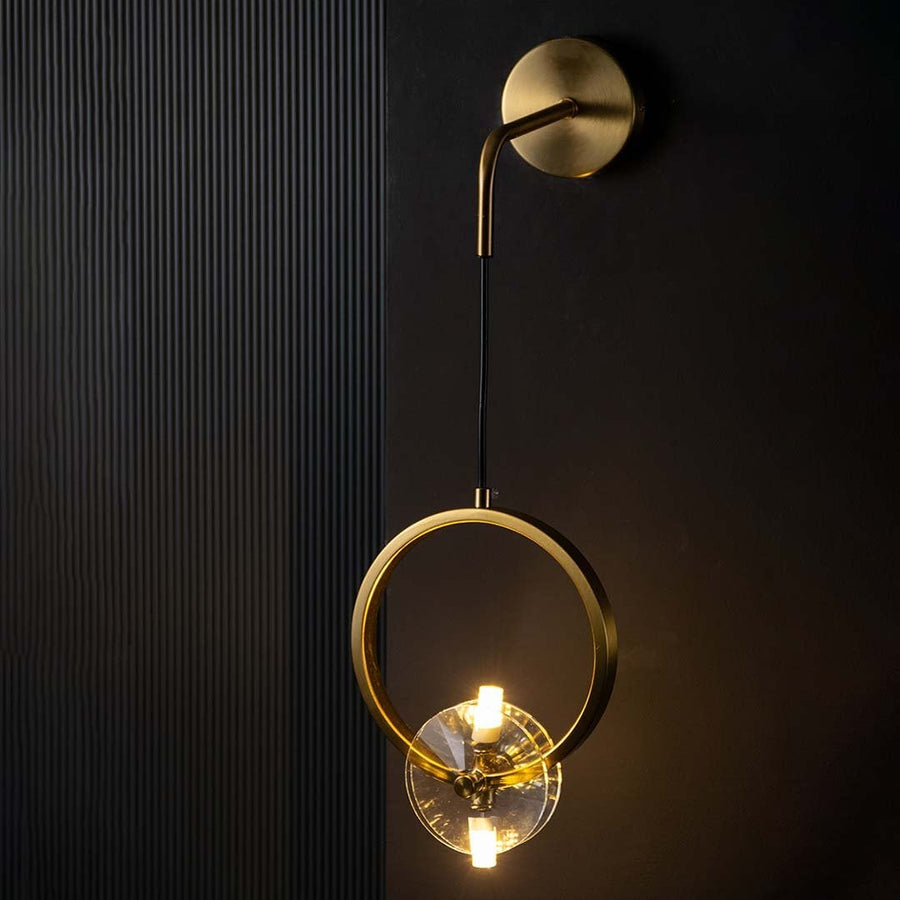 Gold ring wall light glowing warmly on a dark background showcasing its bright ambient illumination and stylish modern circular lighting design.