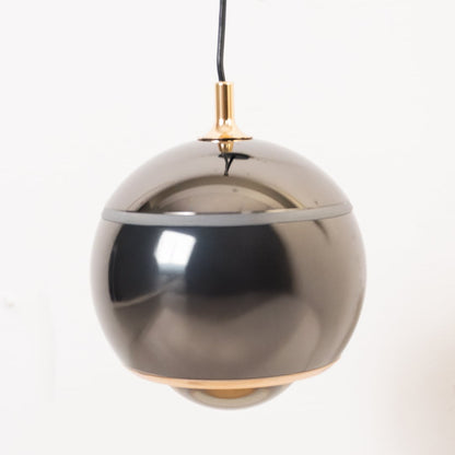 Table lamp look wall light closeup highlighting the smooth black frame and tinted round shade designed for stylish soft focused interior lighting.