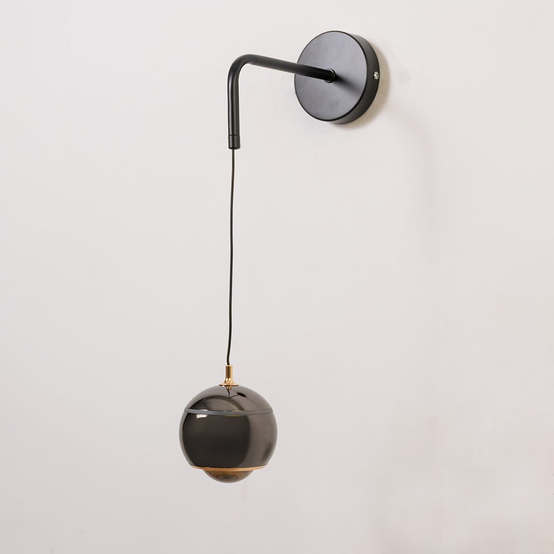 Table lamp look wall light shown with the light off on a white background featuring a matte arm and glossy shade for modern interior decor.