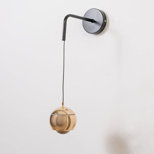 Spherical gold wall light turned off shown on white background with modern metallic design style.