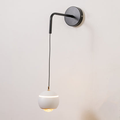 Closeup wall light in black metal finish with hanging glass shade for bedroom or living decor lighting white background.