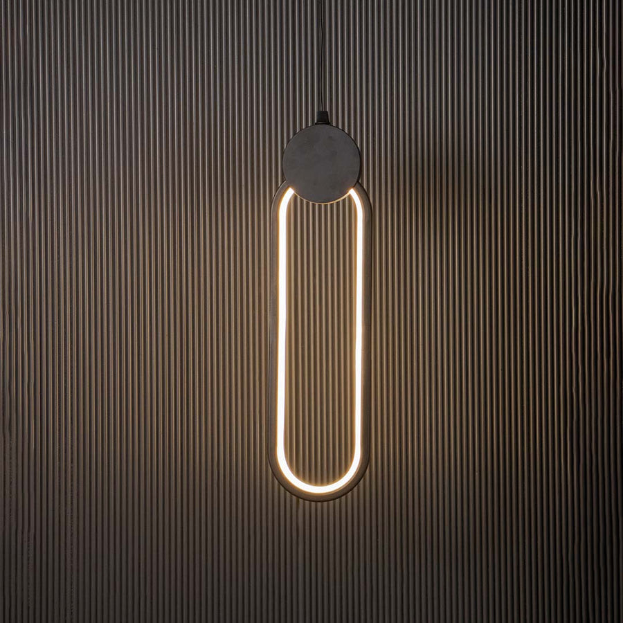 Modern slim oval black LED pendant light glowing brightly on black background ideal for elegant home interiors.