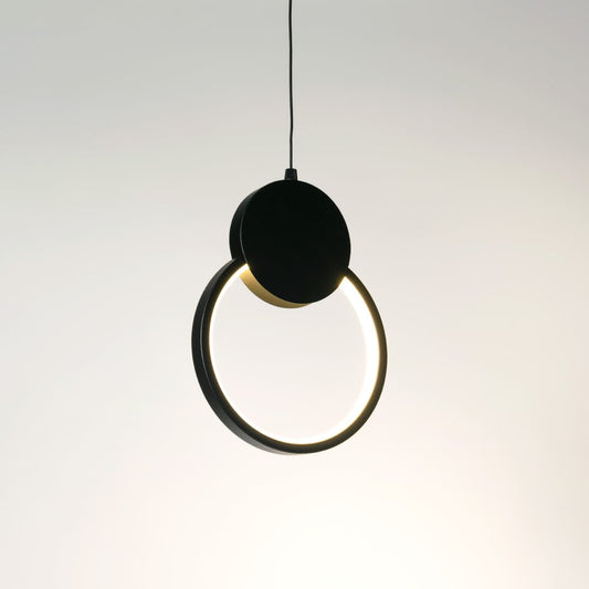 Gold pendant light with frosted glass shade glowing warmly styled in traditional living room interior with cozy wall design.