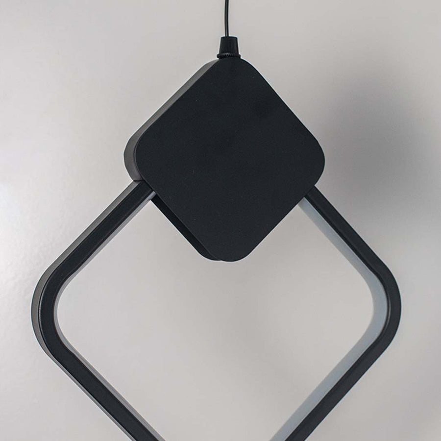 Closeup of black geometric LED pendant lamp highlighting sleek diamond frame design and contemporary finish.