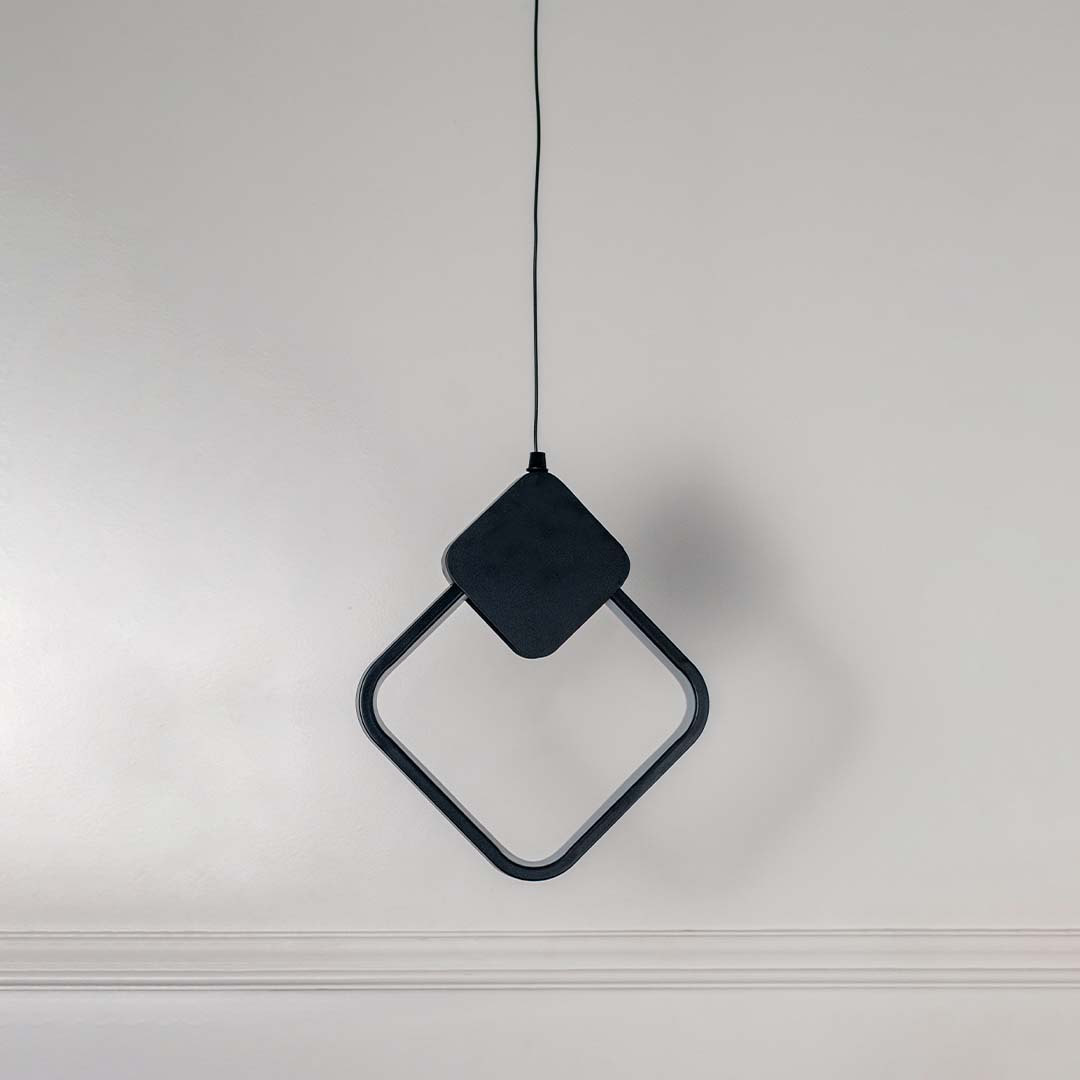 Geometric black LED pendant light with diamond shape frame displayed off on white background for modern interiors.