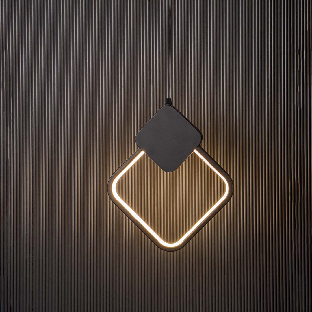 Geometric black LED pendant light with diamond frame glowing on black background for stylish modern home decor.