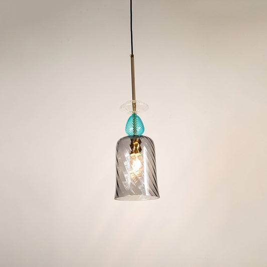 Elegant glass pendant light with glowing grey glass shade and blue top detail shining beautifully against a clean white background.
