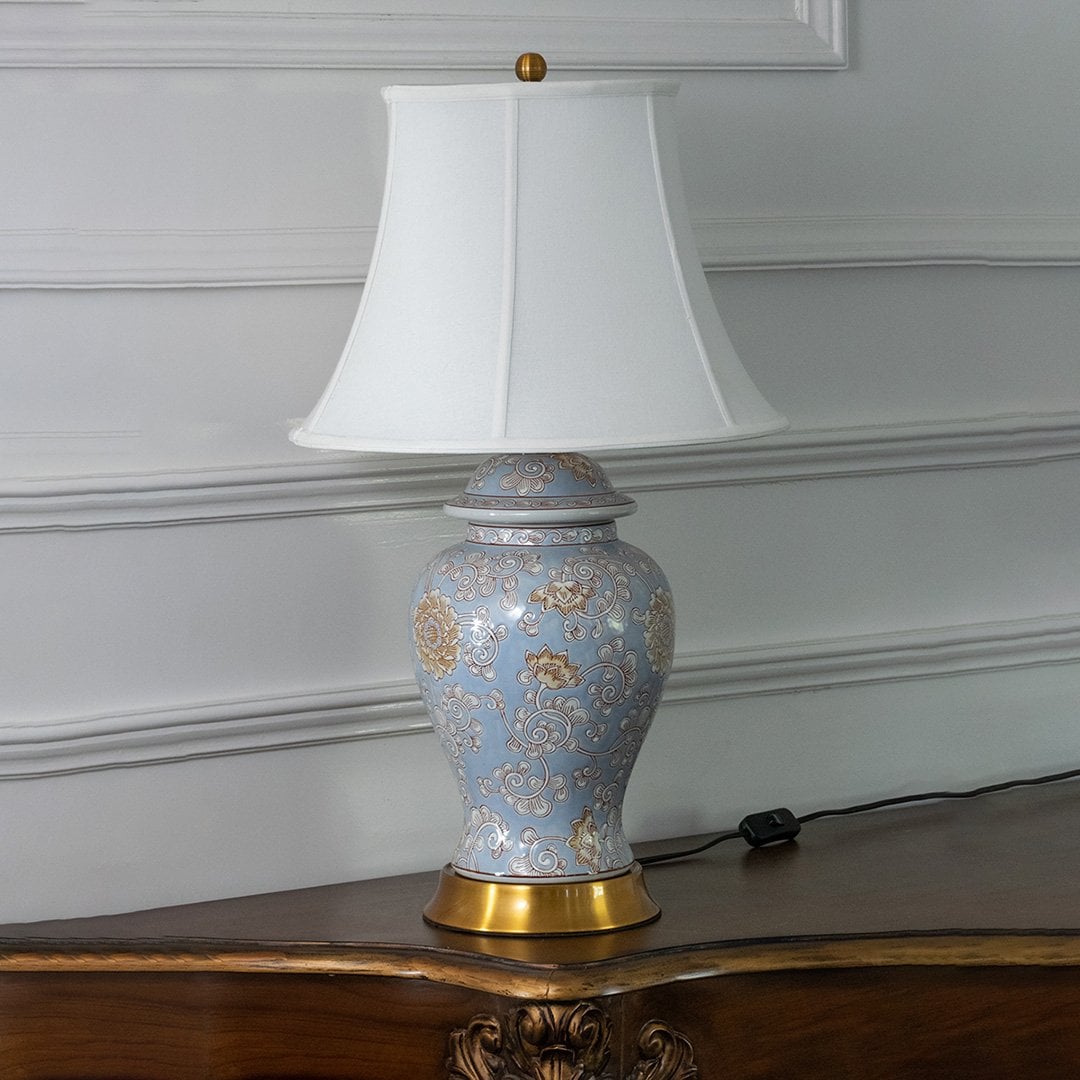 Blue ceramic table lamp with white fabric shade for luxury tabletop lighting and home decor placement styling.