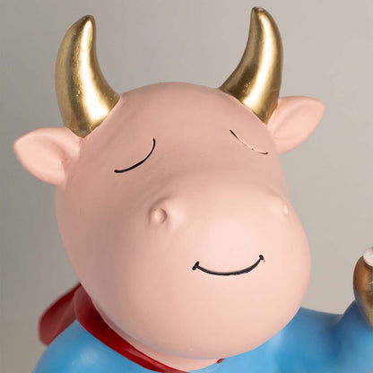 A closeup view of the figurine showing the serene smiling face gold horns and smooth pastel finish with detailed texture and soft highlights on the character design.
