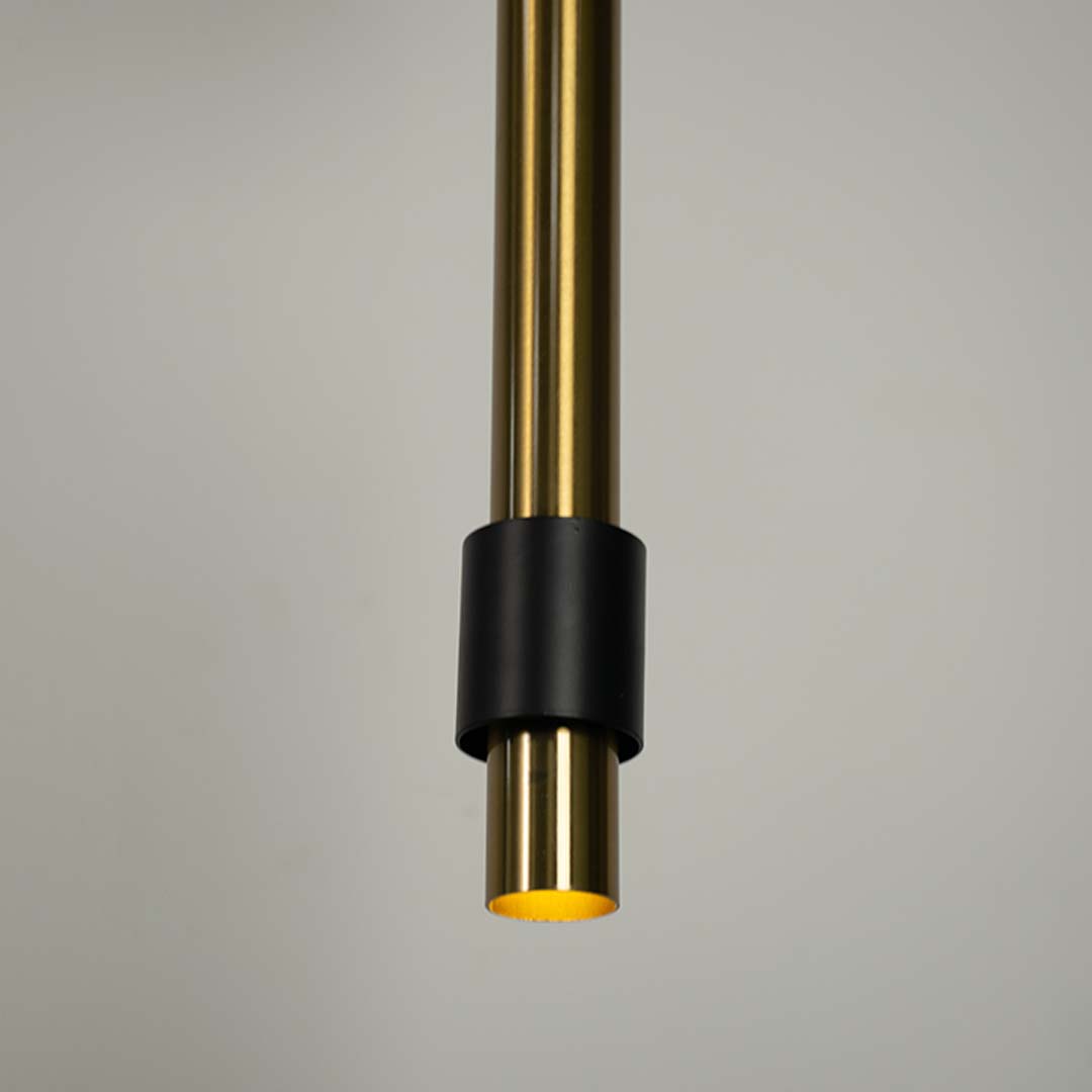 Closeup of black and brass cylindrical pendant light highlighting sleek detailing and craftsmanship.