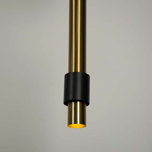 Closeup of black and brass cylindrical pendant light highlighting sleek detailing and craftsmanship.