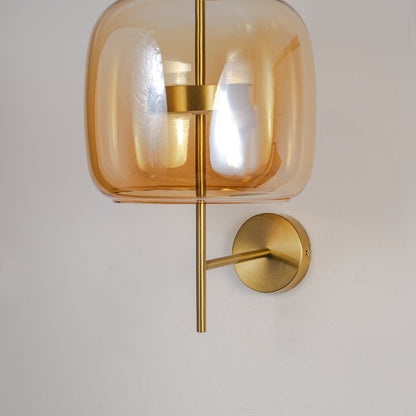 Closeup of amber glass and gold metal wall light for modern bedroom and premium decor styling spaces.