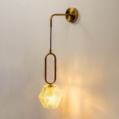 Modern brass pendant wall light with crystal glass shade creating warm luxury interior lighting decor.