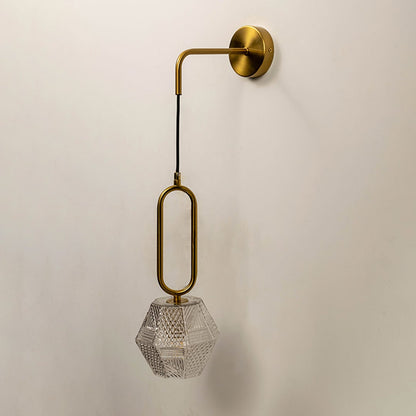 Contemporary brass pendant wall light with textured crystal glass shade for elegant modern interiors.