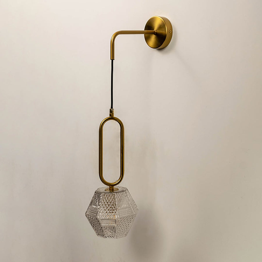 Contemporary brass pendant wall light with textured crystal glass shade for elegant modern interiors.