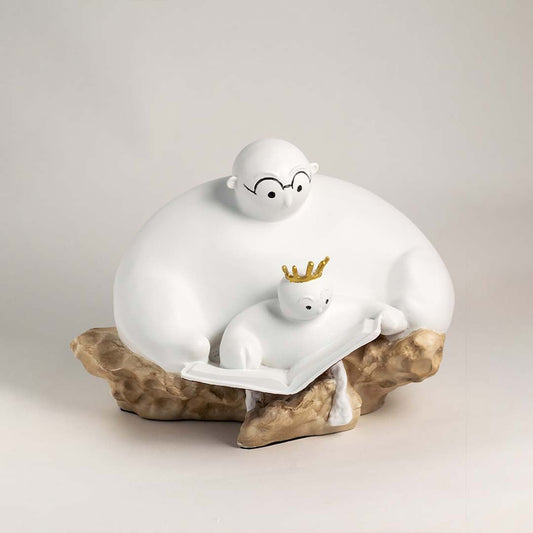 Minimalist parent and child sculpture in white finish with golden crown displayed on plain white background.