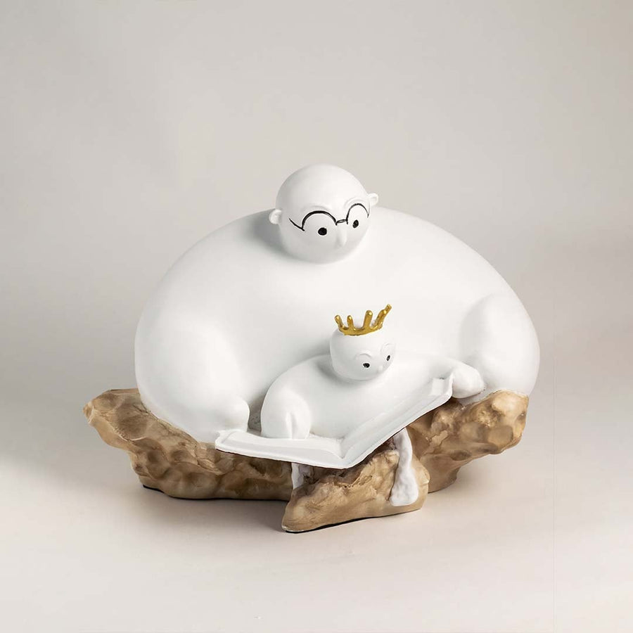 Minimalist parent and child sculpture in white finish with golden crown displayed on plain white background.