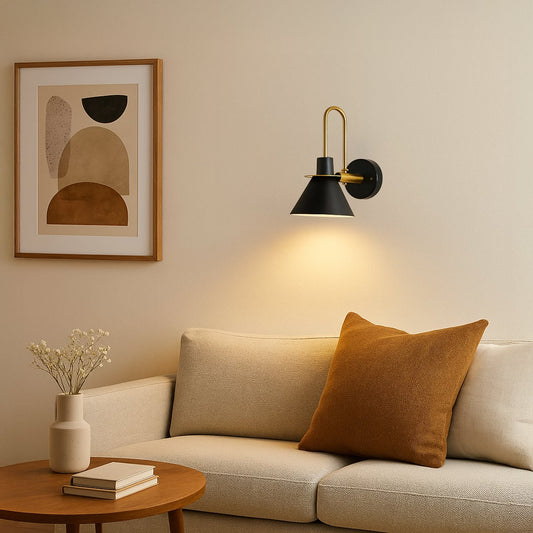 Black and gold wall light glowing warmly beside bed adding elegance and modern luxury to stylish home interiors.