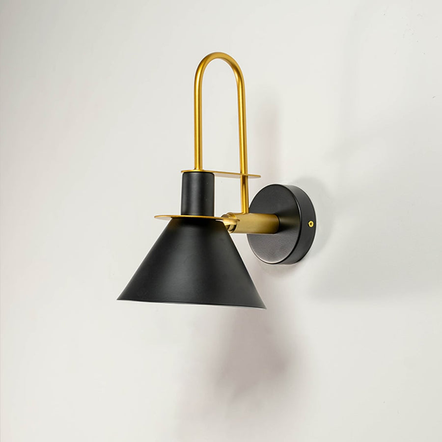Black and gold wall sconce with matte finish displayed on white wall background ideal for luxury home lighting.