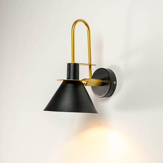 Modern black metal spotlight wall light with brass accents for warm contemporary interior decor.